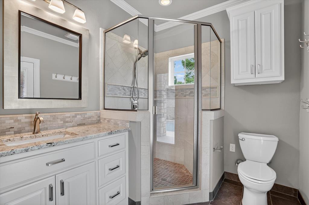 9704 Ravenswood Road Granbury, TX 76049 - Photo 33 of 40 a bathroom with a granite countertop sink toilet and shower