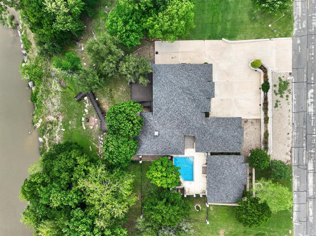 9704 Ravenswood Road Granbury, TX 76049 - Photo 38 of 40 an aerial view of a house with plants and large trees