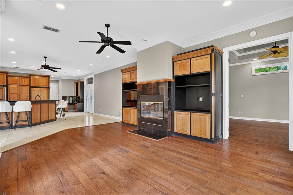 9704 Ravenswood Road Granbury, TX 76049 - Photo 4 of 40 a living room with stainless steel appliances kitchen island wooden floors and living room view