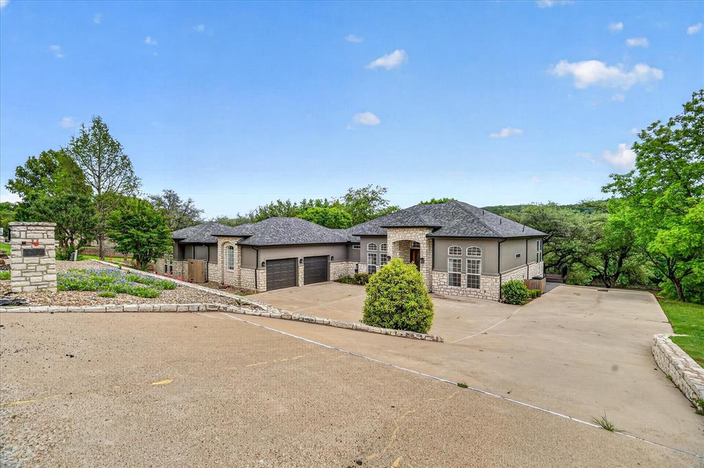 9704 Ravenswood Road Granbury, TX 76049 - Photo 6 of 40 a front view of a house with a yard and potted plants
