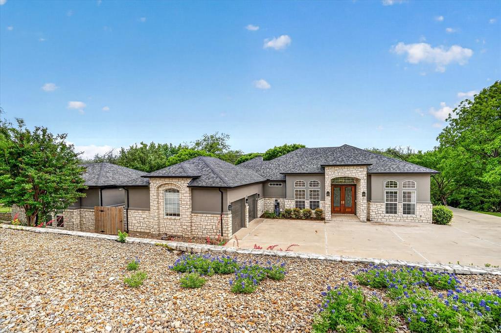 9704 Ravenswood Road Granbury, TX 76049 - Photo 8 of 40 a front view of a house with a yard and potted plants