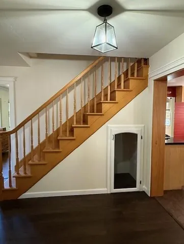 a view of entryway and hall with wooden floor
