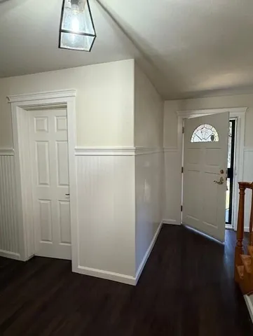 an empty room with wooden floor and closet