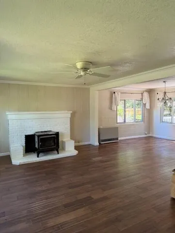 wooden floor fireplace and natural light in room