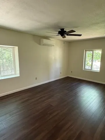a view of a room with wooden floor and a window
