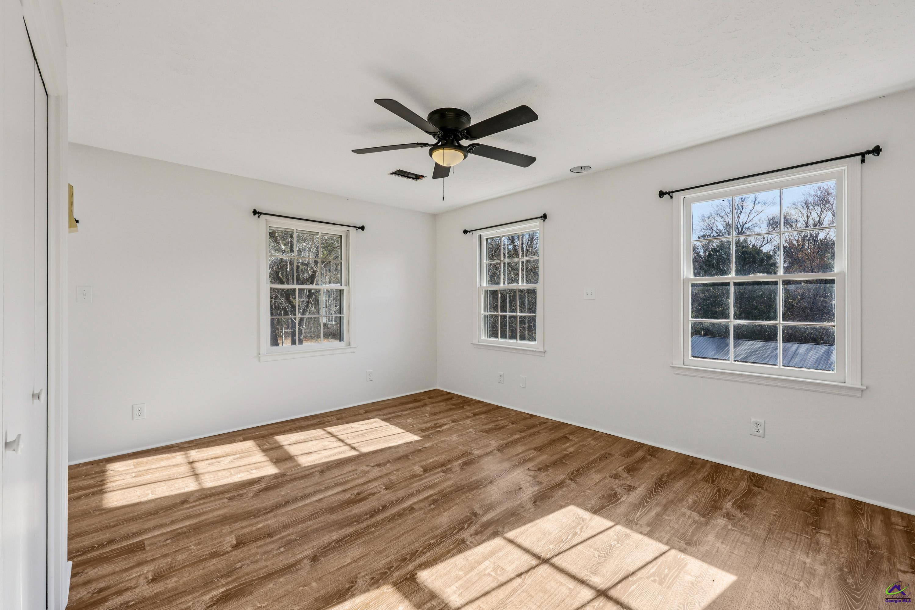 548 Greene Settlement Road Gray, GA 31032 - Photo 28 of 68 a view of empty room with wooden floor and fan