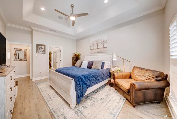 a spacious bedroom with a bed couch and window