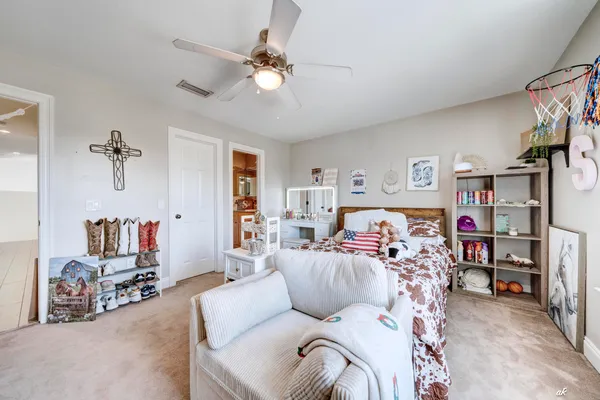 a bedroom with furniture and a chandelier