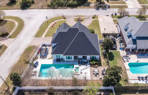 an aerial view of house with a swimming pool patio and outdoor seating