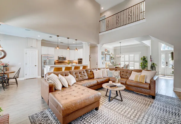 a living room with furniture a rug and a chandelier