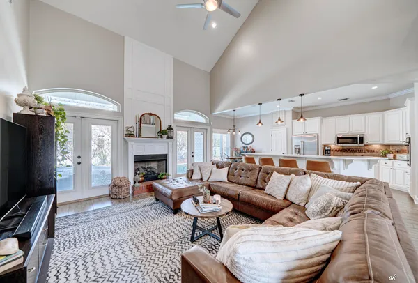 a living room with furniture a fireplace and a flat screen tv