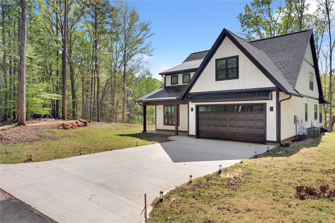 407 Blue Ridge Court Westminster, SC 29693 - Photo 4 of 48 This newly constructed home features a crisp white exterior, dark trim, and an attached garage.
