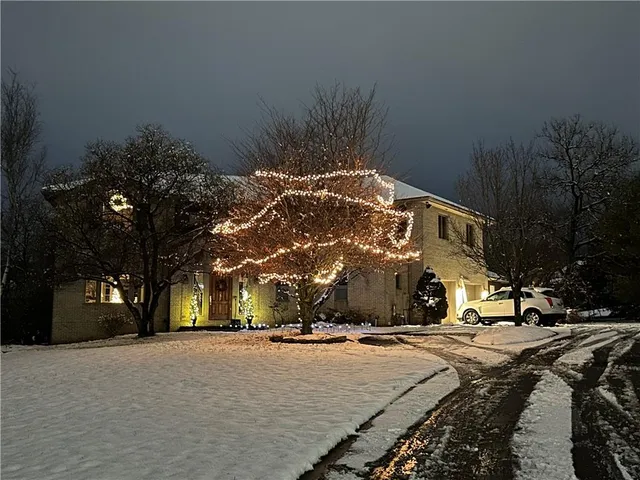 a view of a building with snow on the road