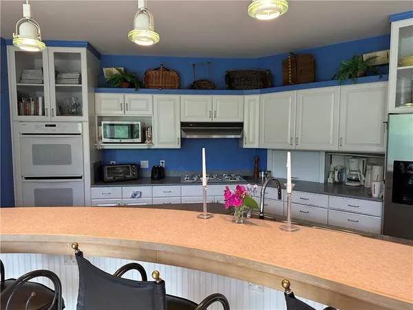 a kitchen with cabinets a sink and appliances