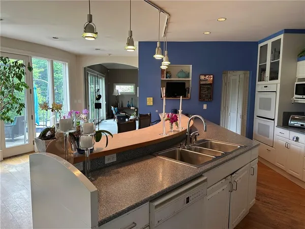 a kitchen with stainless steel appliances a sink a stove and a refrigerator
