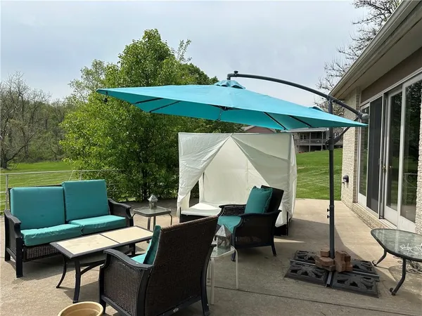 a backyard of a house with outdoor seating