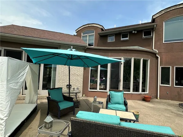 a bedroom with a large bed and a chandelier