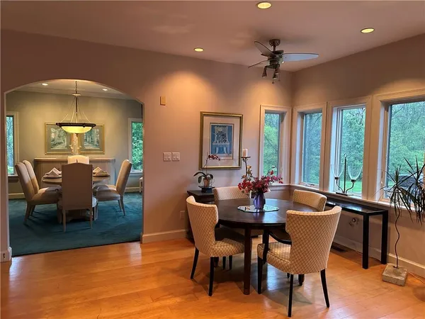 a dining room with furniture a chandelier and window