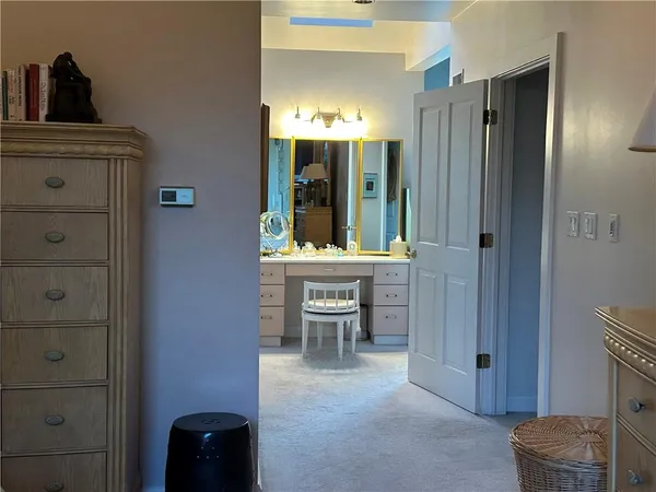 a spacious bathroom with a double vanity sink and a mirror