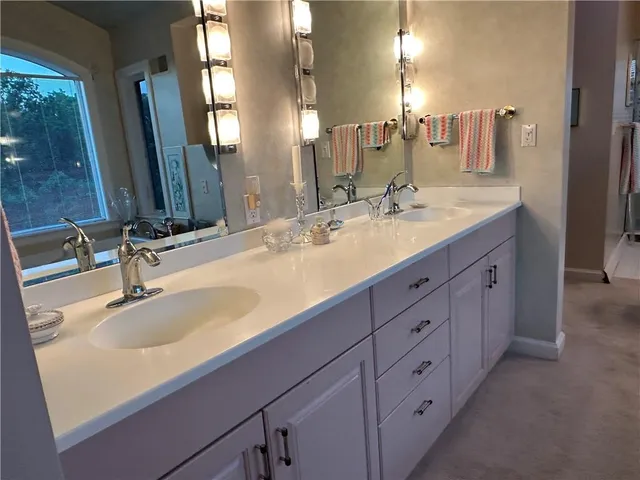 a bathroom with a bathtub and next to a window