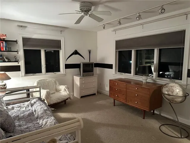 a bed sitting in a bedroom next to a window