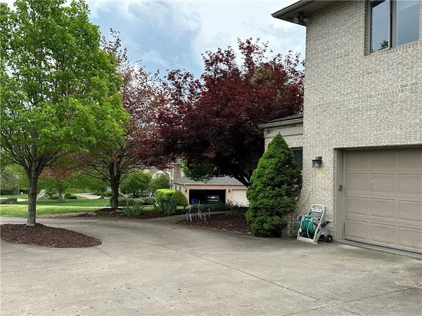 an outdoor view of a house with a garden