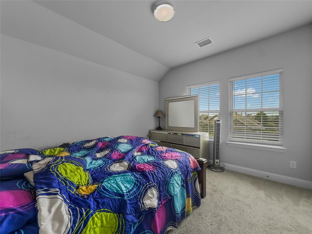 116 Chaco Drive Forney, TX 75126 - Photo 22 of 27 a bedroom with a bed and a window