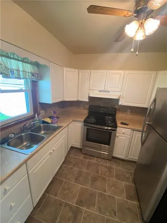 a kitchen that has a sink and a stove