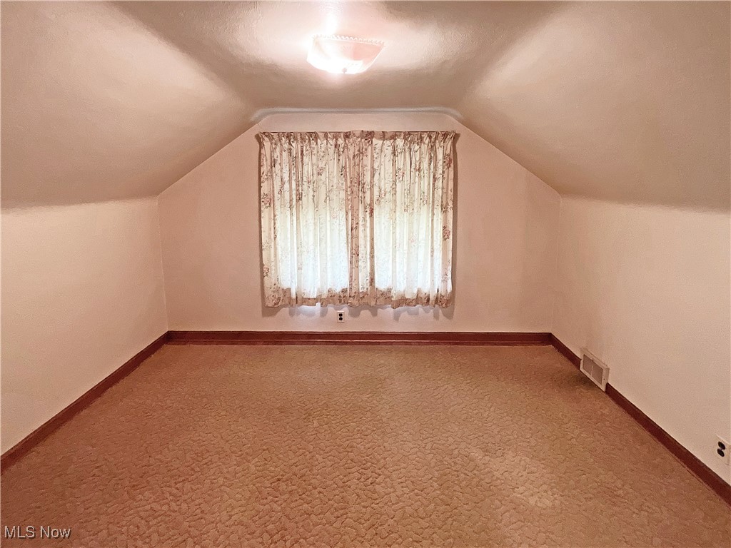 63 Mc Coll Road Colliers, WV 26035 - Photo 10 of 17 Additional living space featuring carpet floors and vaulted ceiling