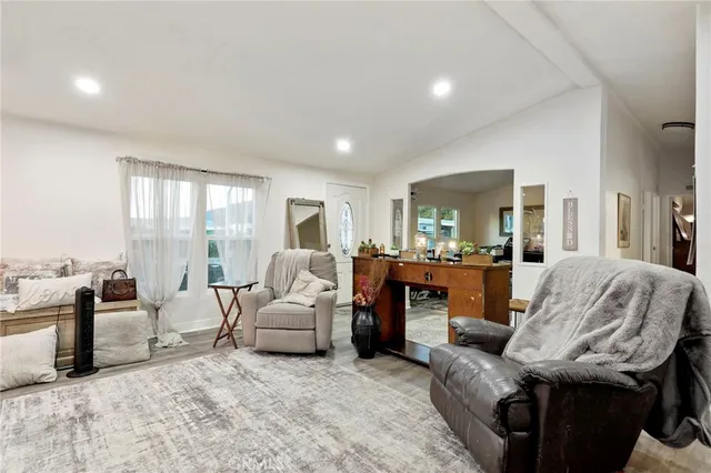 a living room with furniture a large window and a fireplace