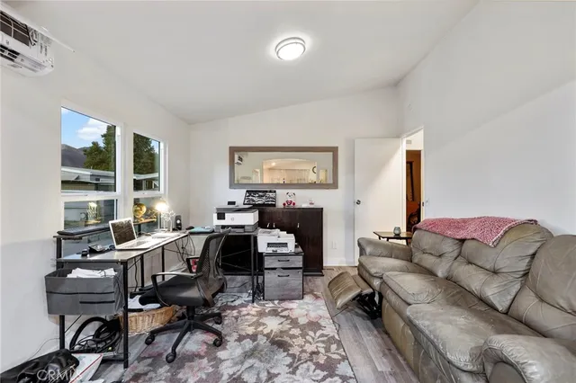 a view of a livingroom with workspace and a couch