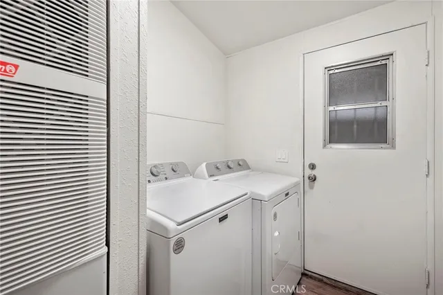 a utility room with cabinets washer and dryer
