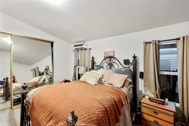 a bedroom with a bed and mirror