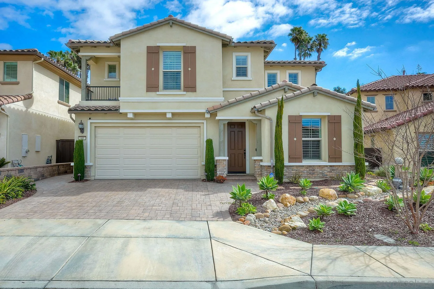 449 Cota Lane Vista, CA 92083 - Photo 2 of 2 a front view of a house with a yard and potted plants