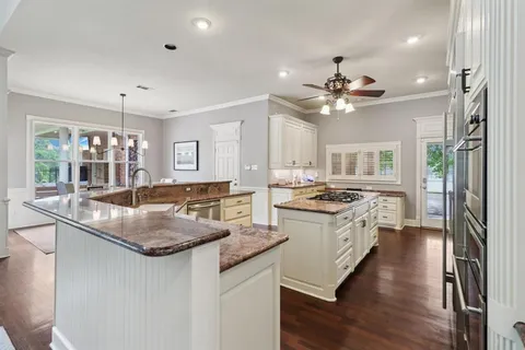 a kitchen with stainless steel appliances granite countertop a stove and a sink