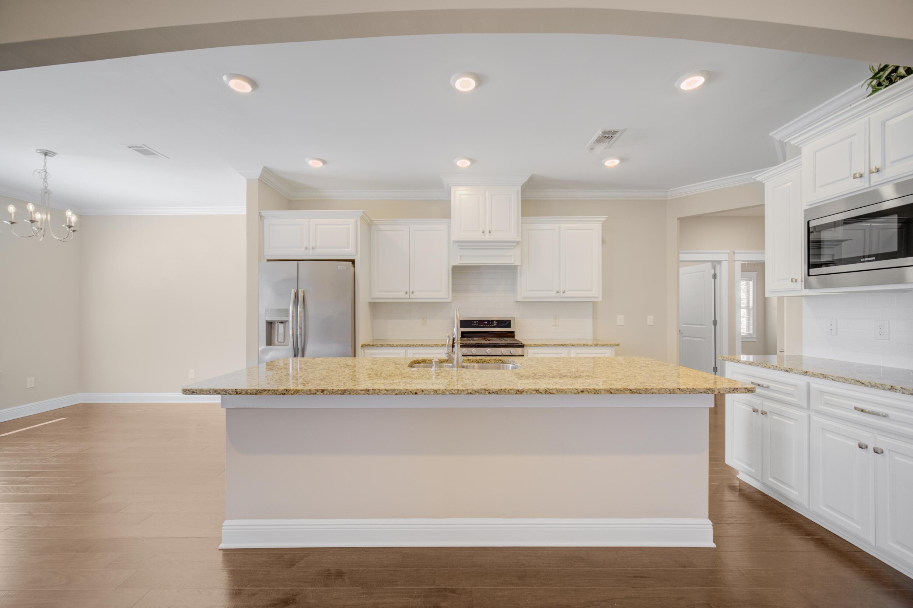 136 Buxtons Way Freeport, FL 32439 - Photo 12 of 59 a large kitchen with kitchen island a sink stainless steel appliances and cabinets