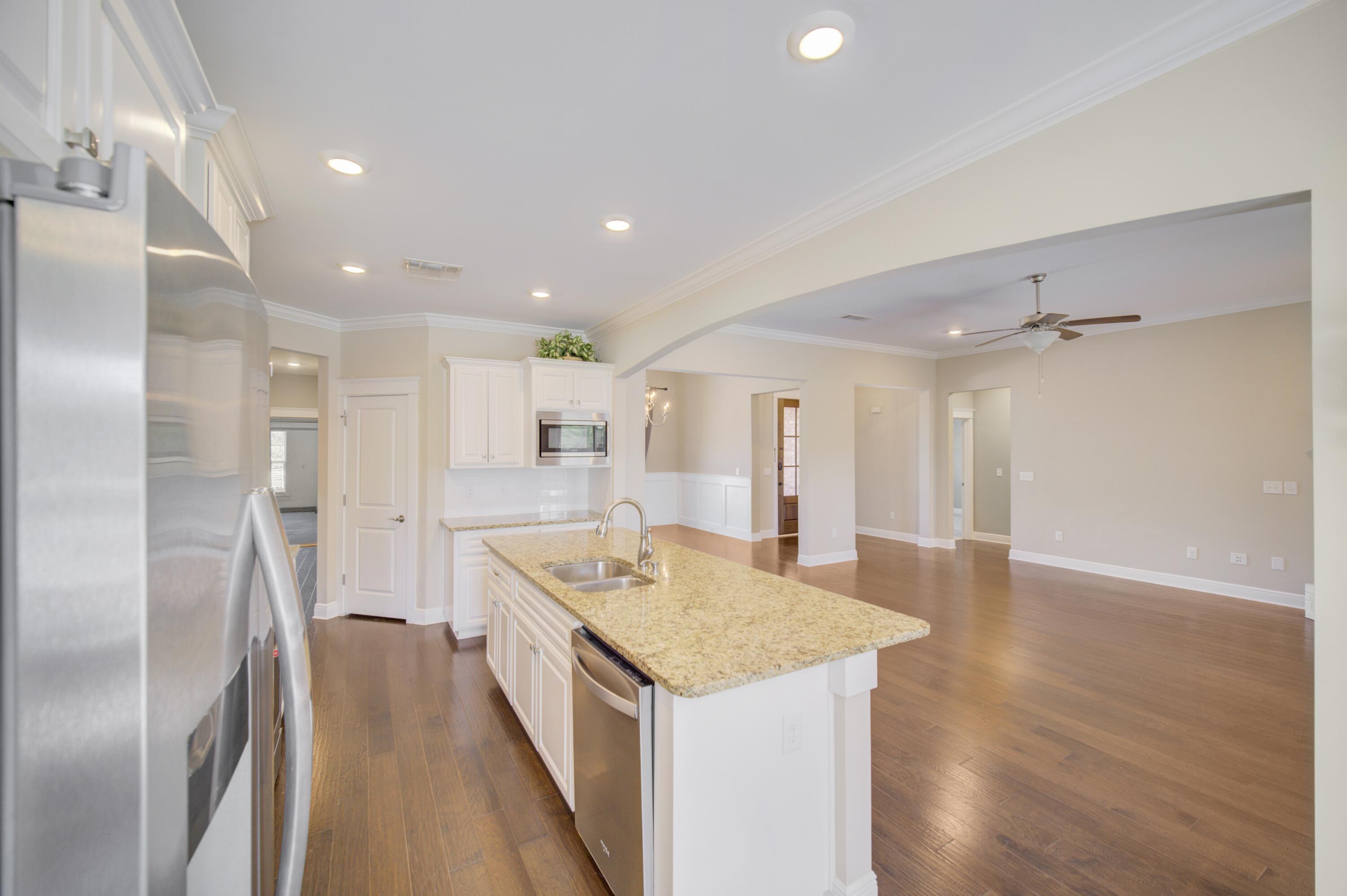 136 Buxtons Way Freeport, FL 32439 - Photo 14 of 59 a kitchen with a center island wooden floor and stainless steel appliances