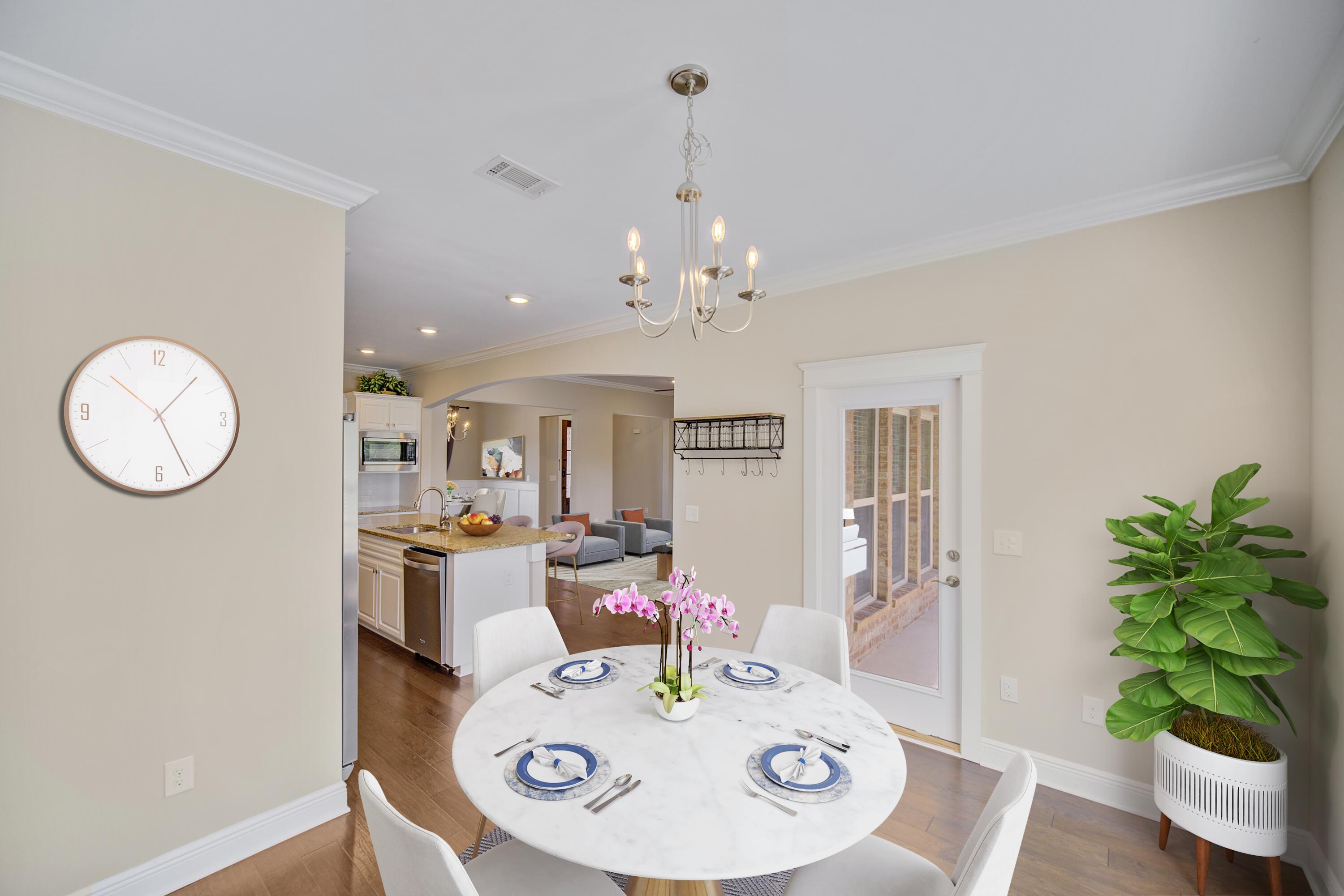 136 Buxtons Way Freeport, FL 32439 - Photo 18 of 59 a view of a dining room with furniture a chandelier and wooden floor