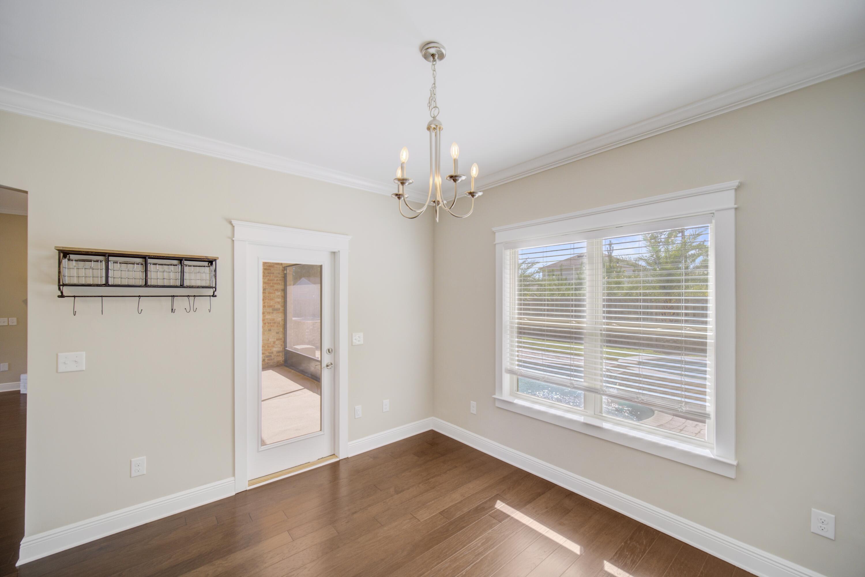136 Buxtons Way Freeport, FL 32439 - Photo 19 of 59 a view of an empty room with wooden floor and a window
