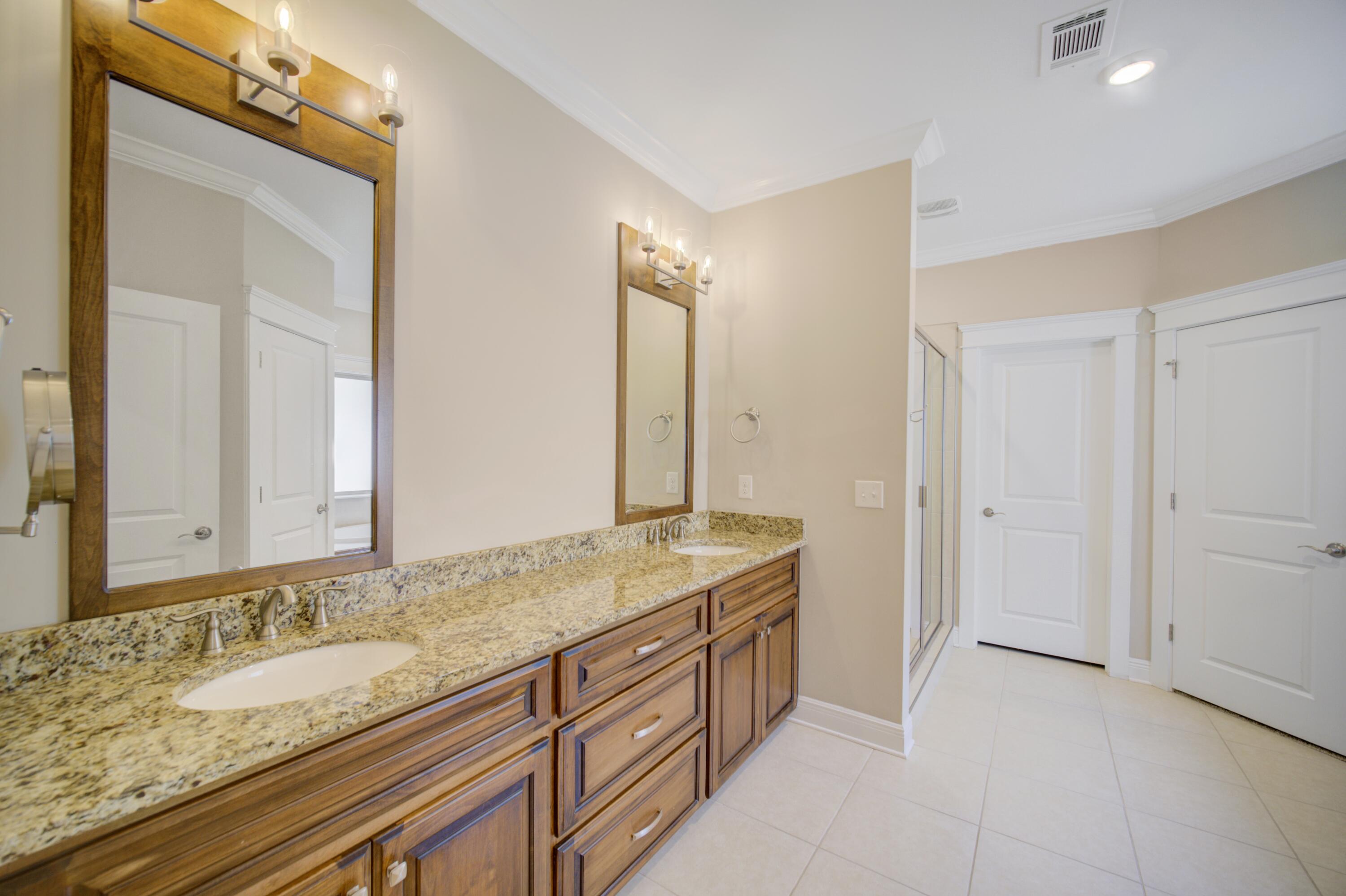 136 Buxtons Way Freeport, FL 32439 - Photo 24 of 59 a bathroom with a granite countertop double vanity sink and a mirror