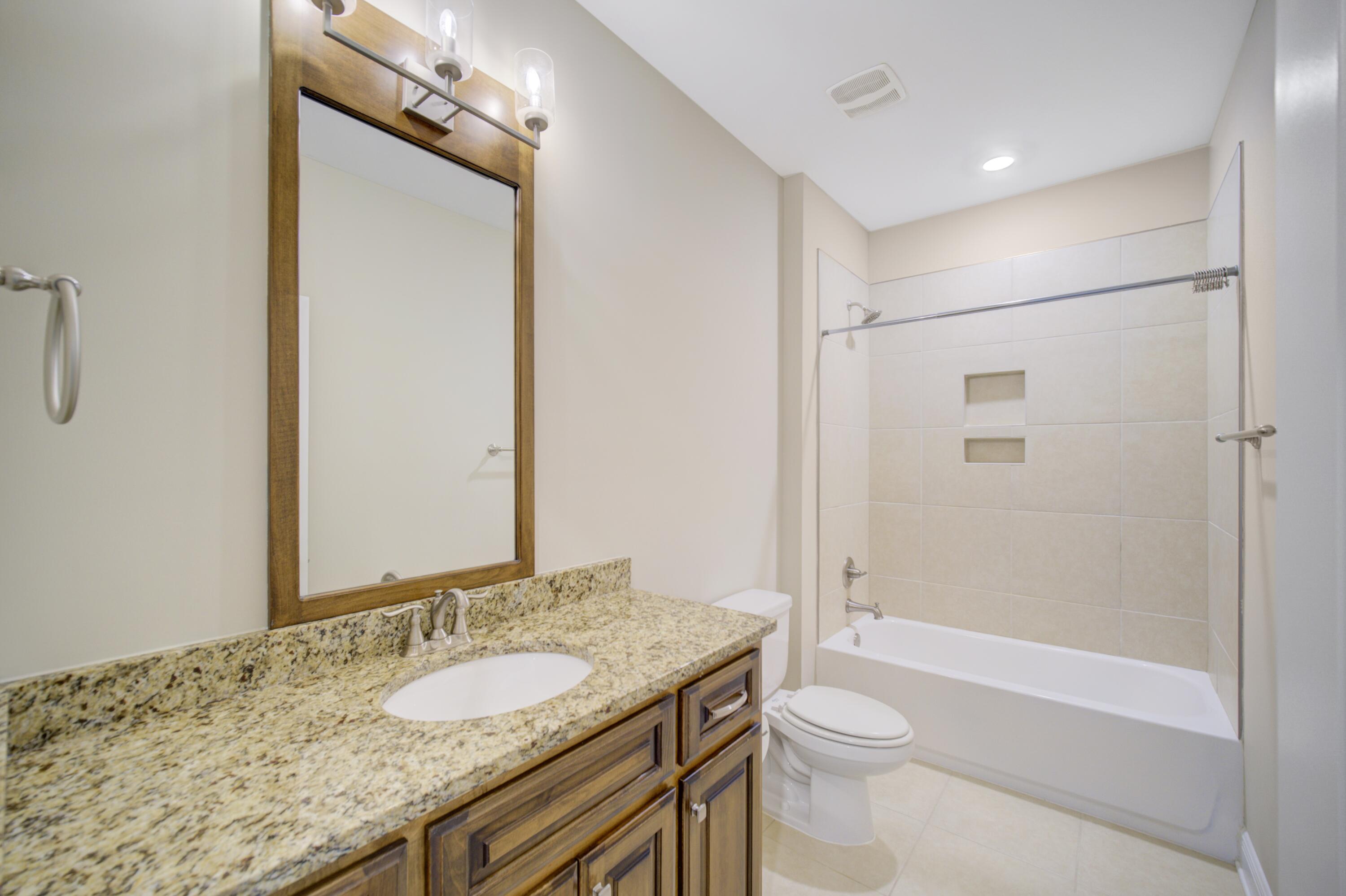 136 Buxtons Way Freeport, FL 32439 - Photo 29 of 59 a bathroom with a granite countertop sink toilet and shower