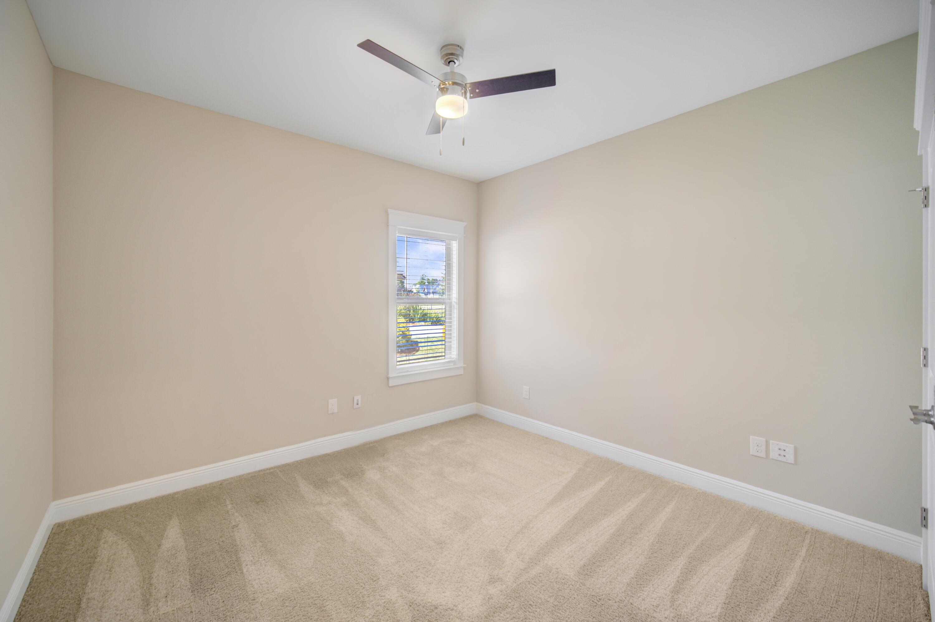 136 Buxtons Way Freeport, FL 32439 - Photo 30 of 59 an empty room with a window and a ceiling fan