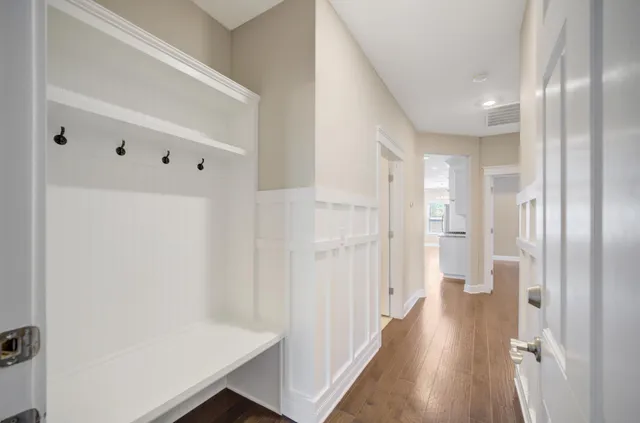 an empty room with a window and ceiling fan