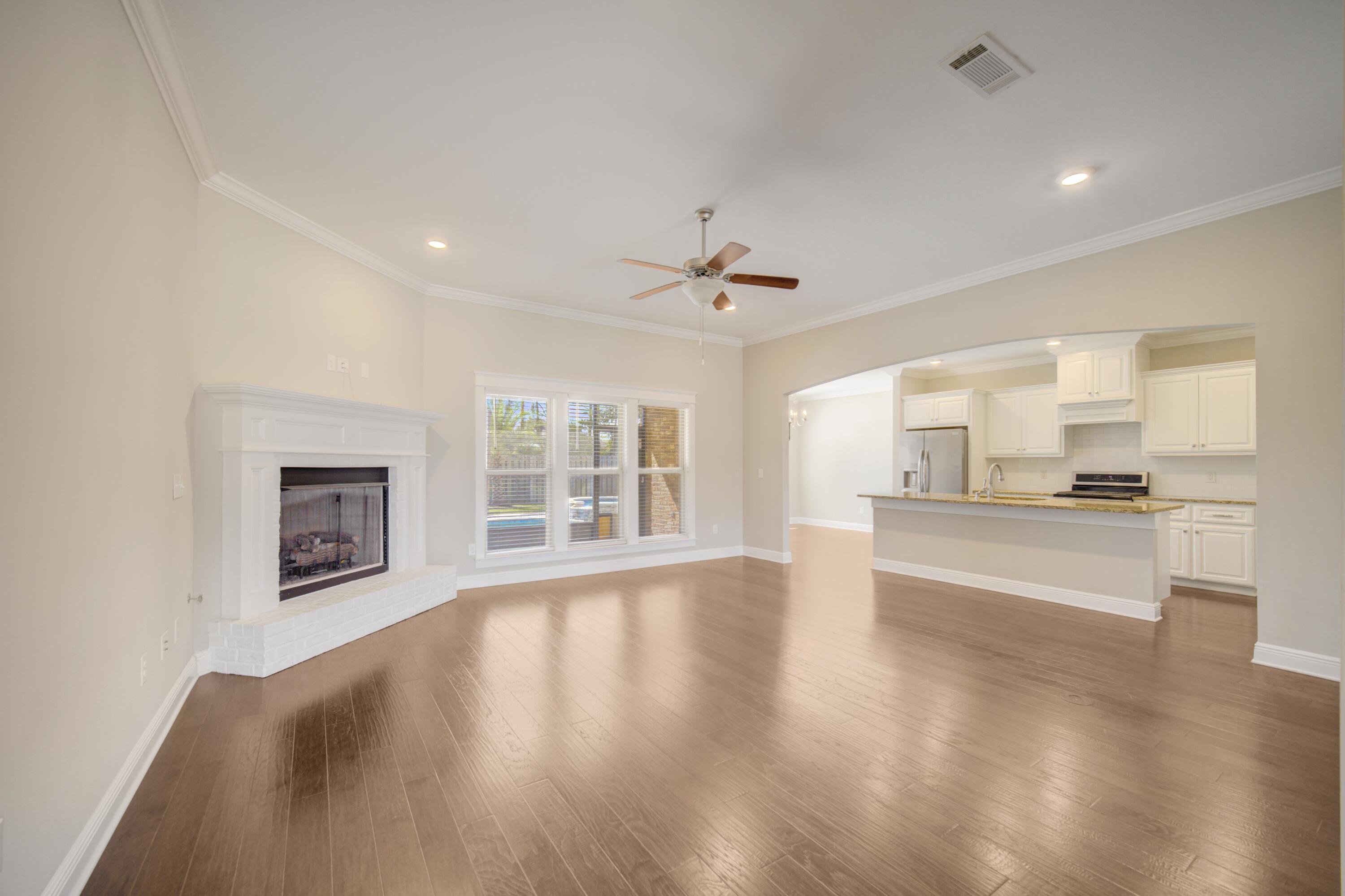 136 Buxtons Way Freeport, FL 32439 - Photo 4 of 59 a view of an empty room with a window and wooden floor