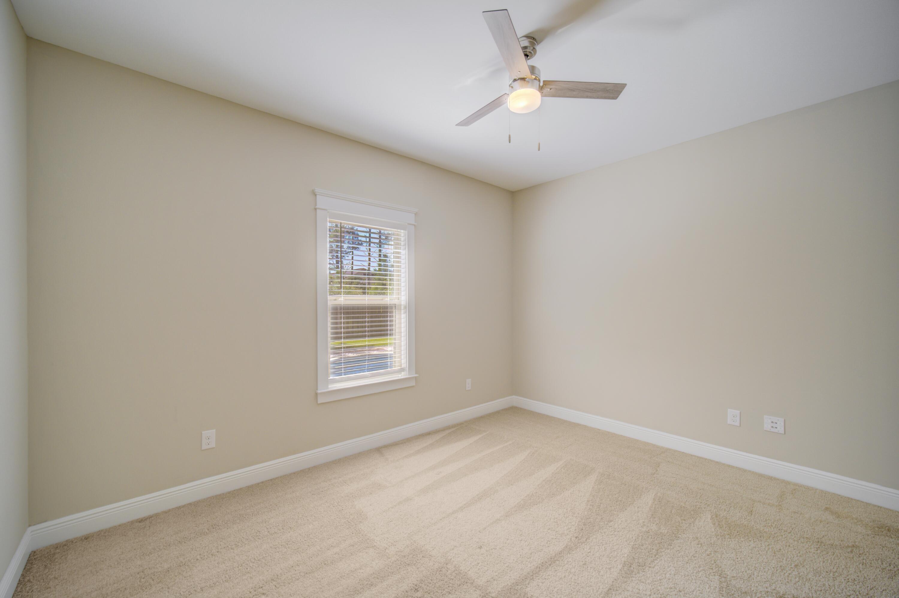 136 Buxtons Way Freeport, FL 32439 - Photo 42 of 59 an empty room with a window and ceiling fan