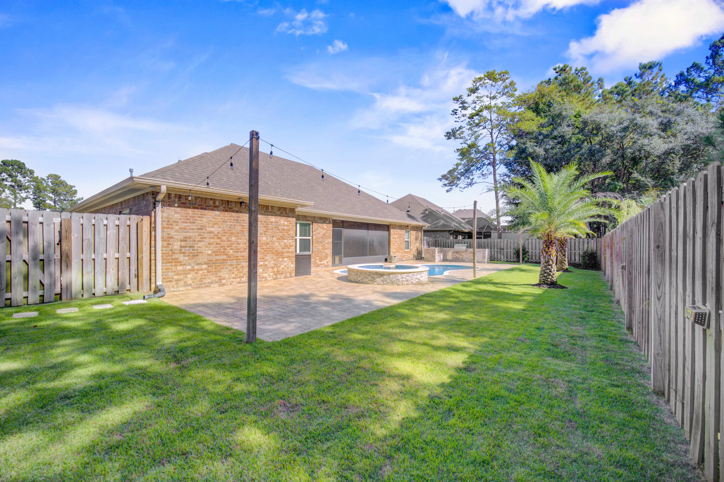 136 Buxtons Way Freeport, FL 32439 - Photo 44 of 59 a front view of a house with garden
