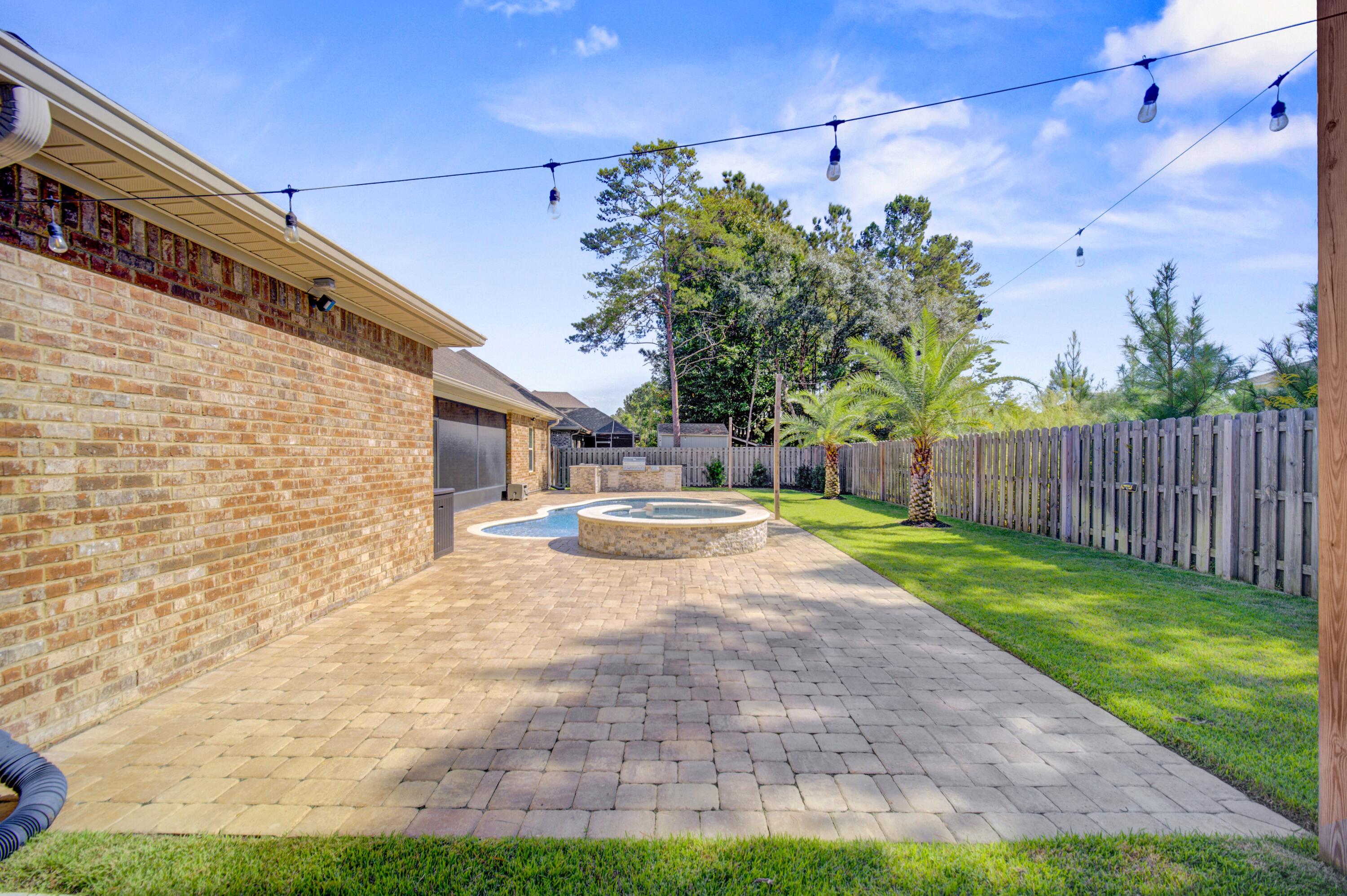 136 Buxtons Way Freeport, FL 32439 - Photo 45 of 59 a view of a yard with brick wall and a chair