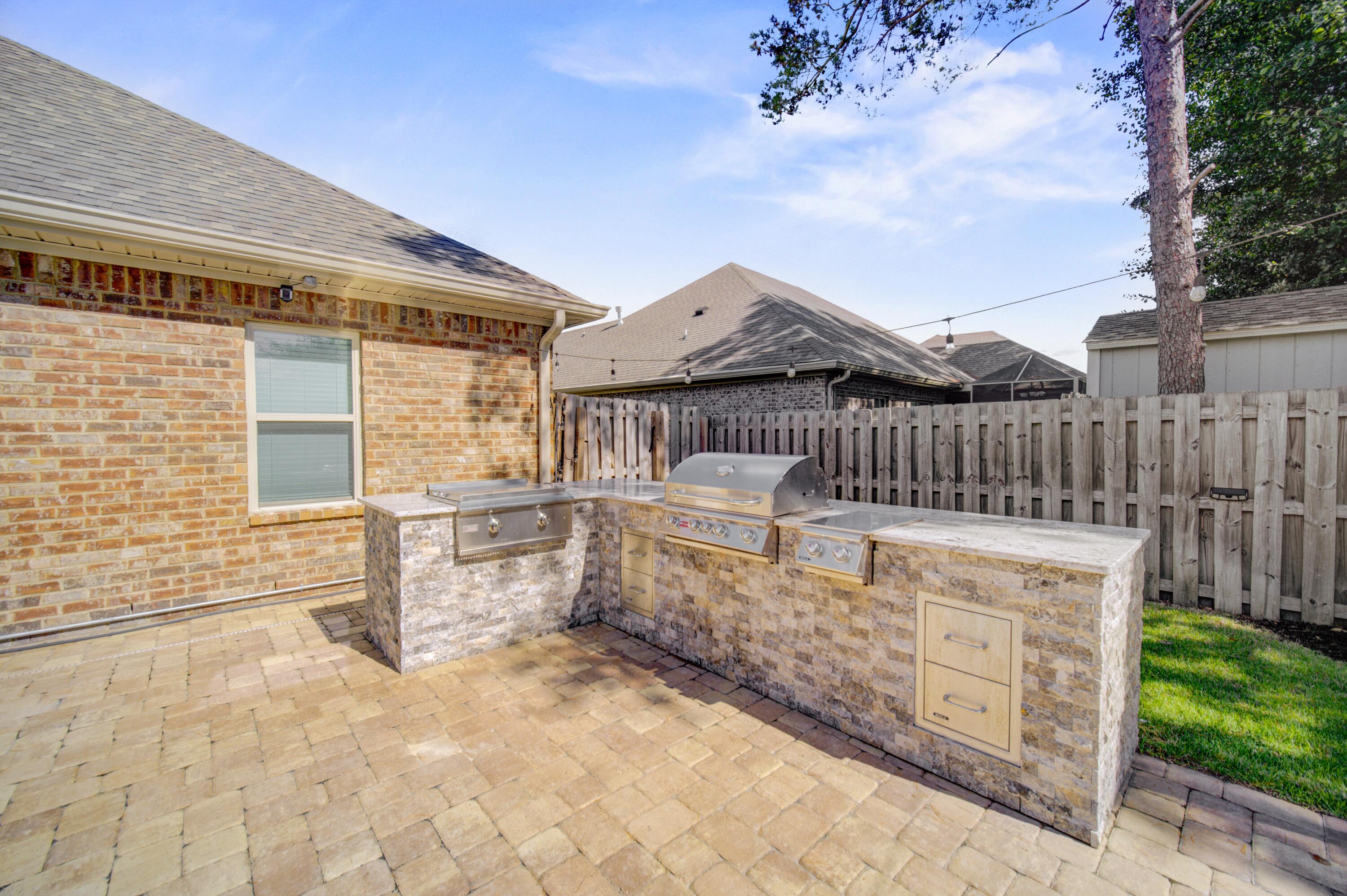 136 Buxtons Way Freeport, FL 32439 - Photo 47 of 59 a front view of a house with a wooden fence