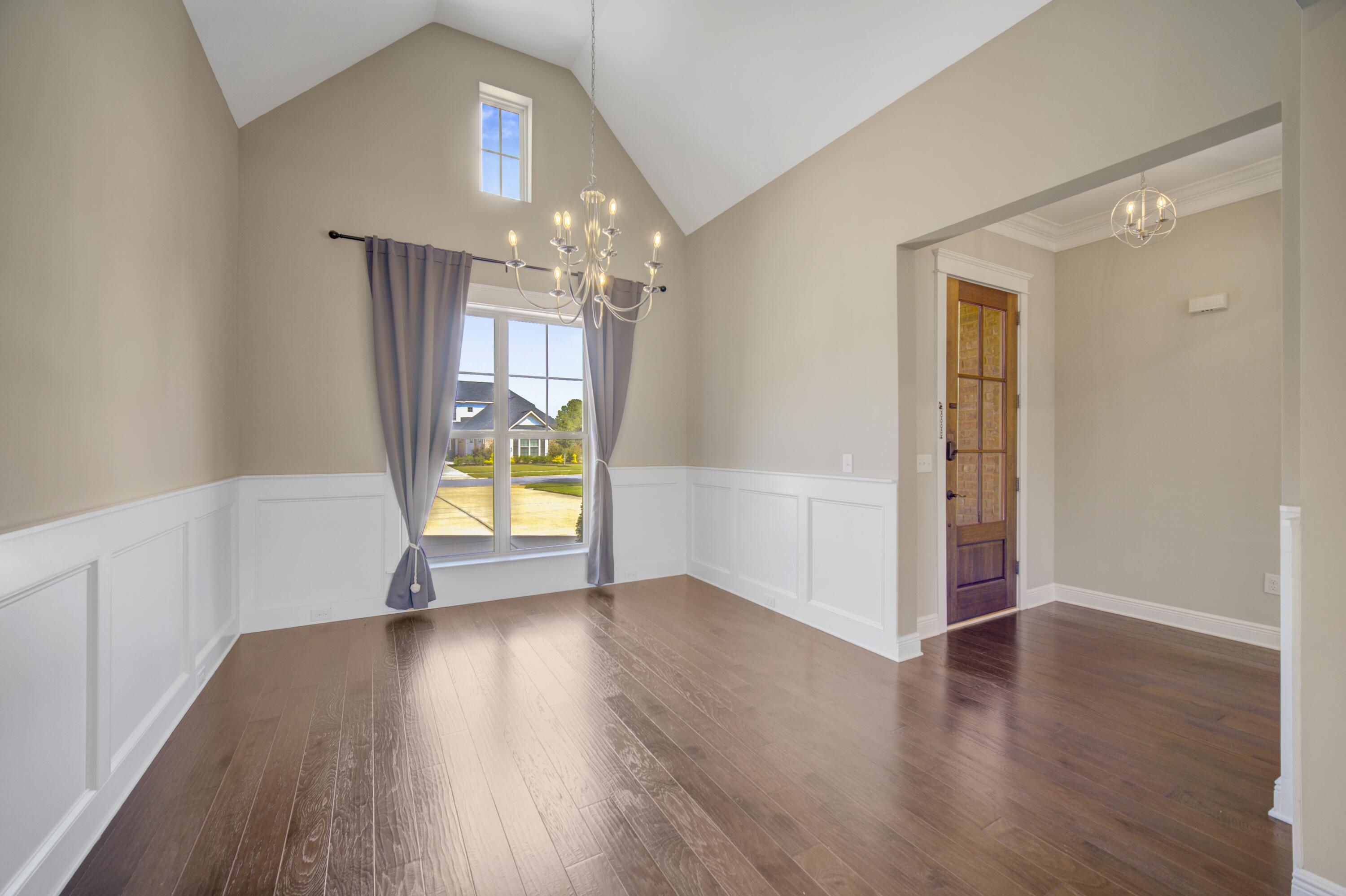 136 Buxtons Way Freeport, FL 32439 - Photo 9 of 59 a view of an empty room with window and wooden floor