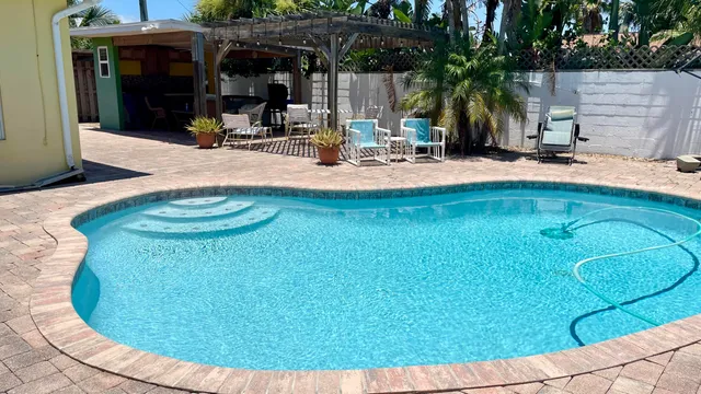 a view of a house with backyard outdoor seating area and barbeque oven